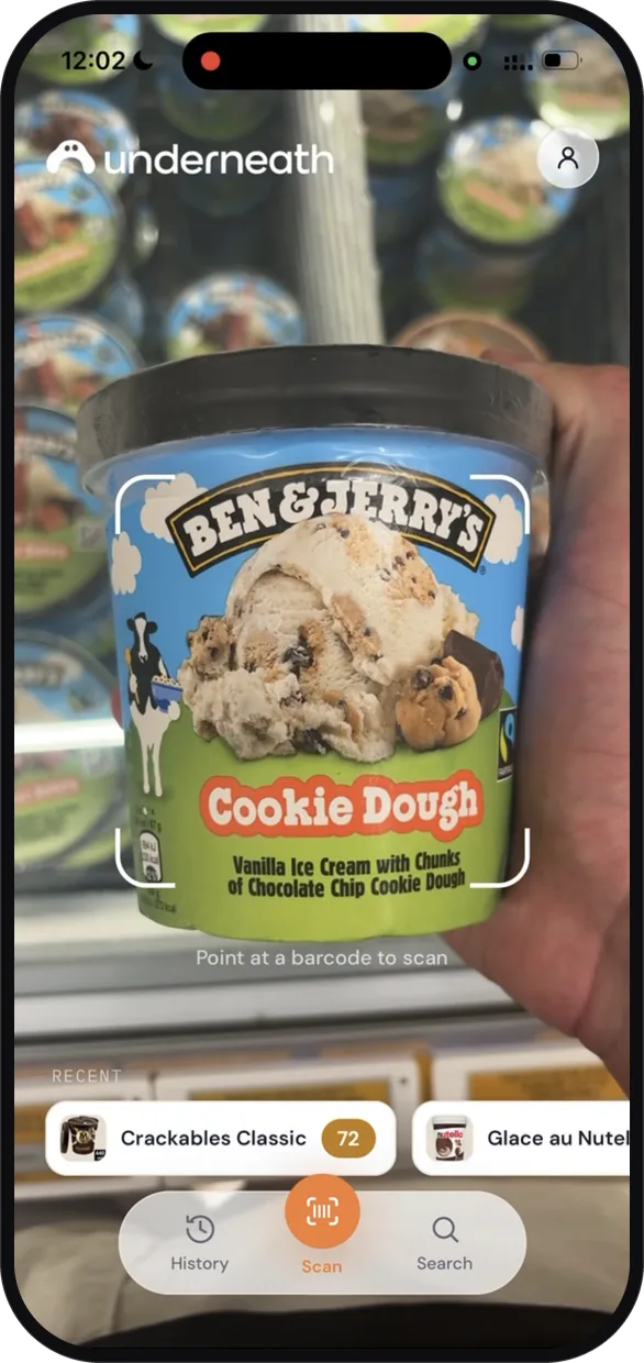 The Underneath app held up in a supermarket freezer aisle, a tub of Ben and Jerry's Cookie Dough ice cream framed in the scanner
